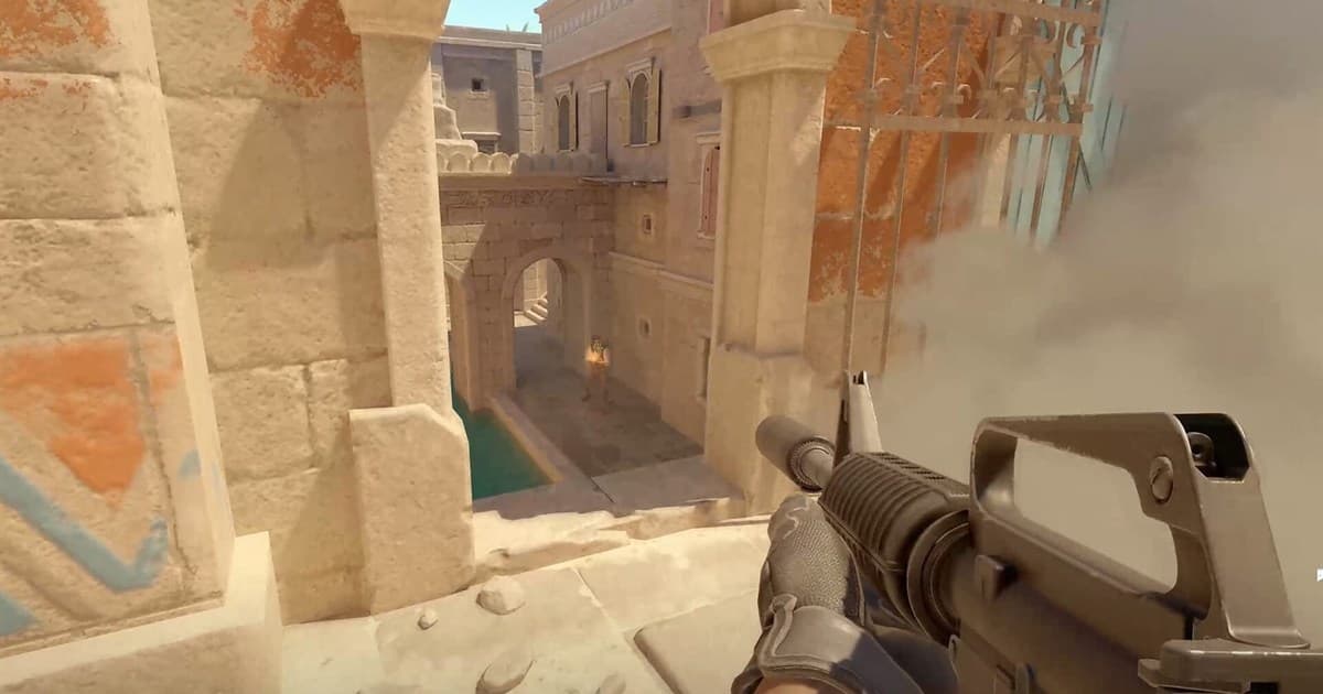 First-person Counter-Strike 2 view with a rifle on a sandy map
