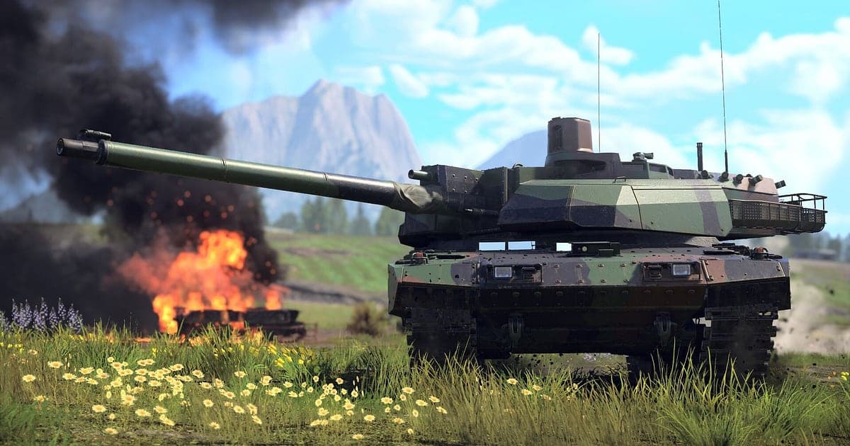 War Thunder ground battle on a meadow of wildflowers, with a camouflaged tank aiming its gun while a destroyed vehicle burns behind it in black smoke