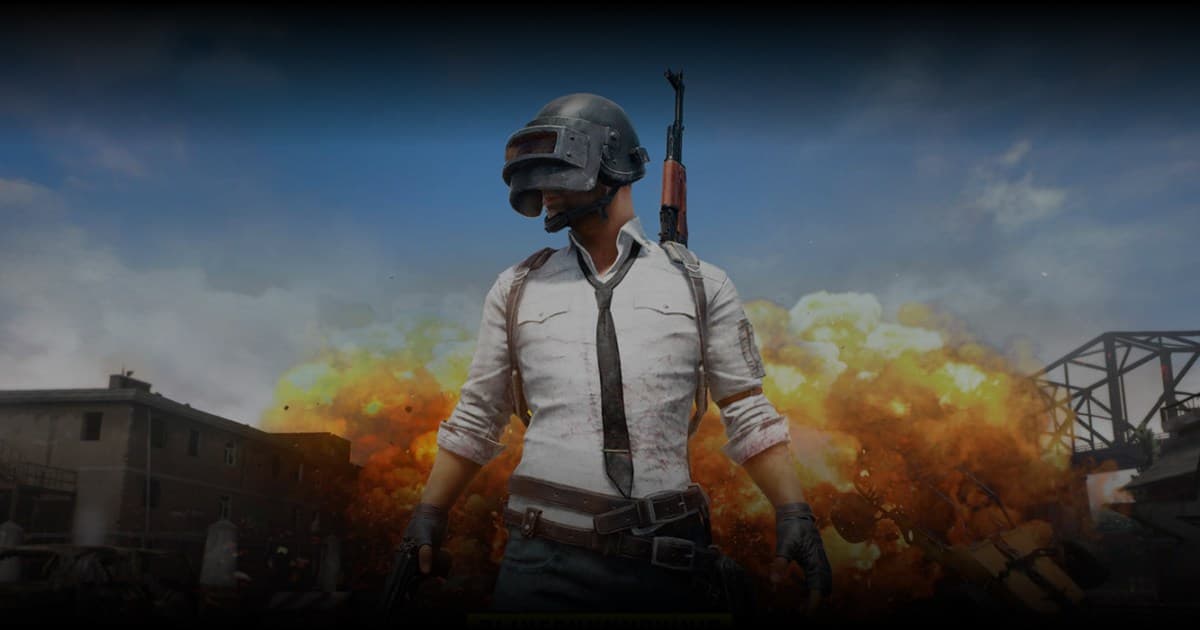 Helmeted PUBG character standing in front of an exploding battleground