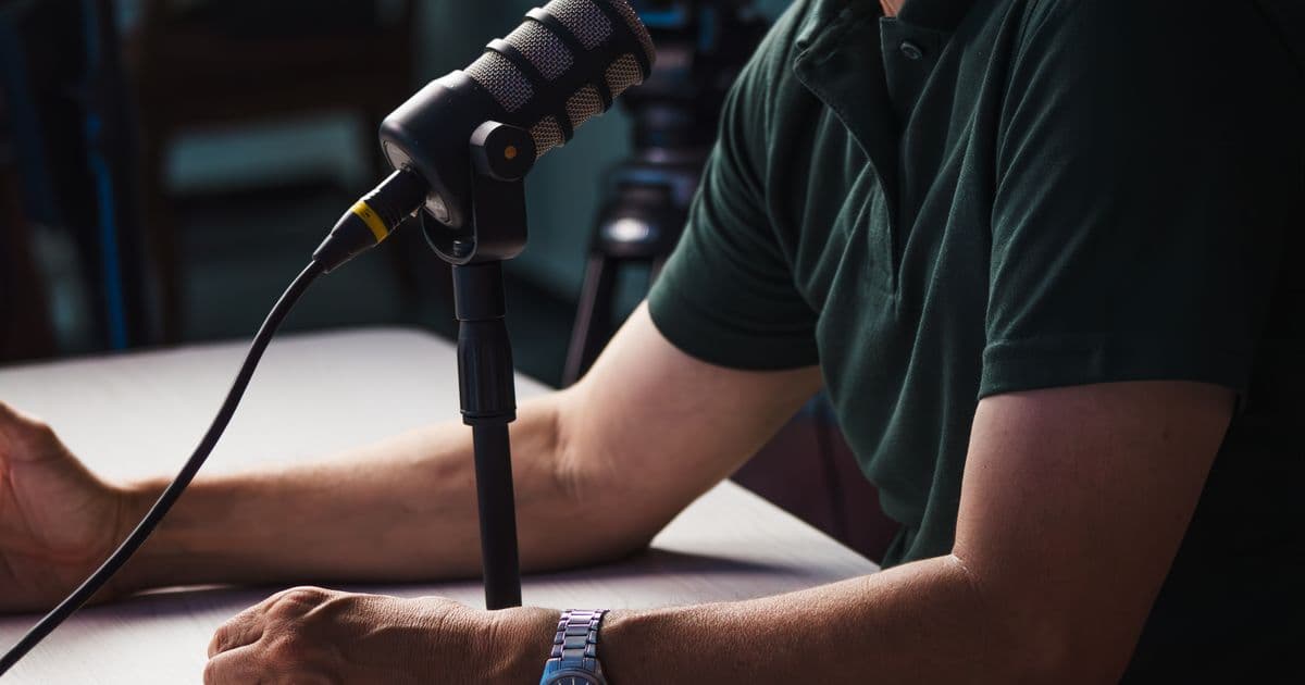A creator making video content in front of a microphone